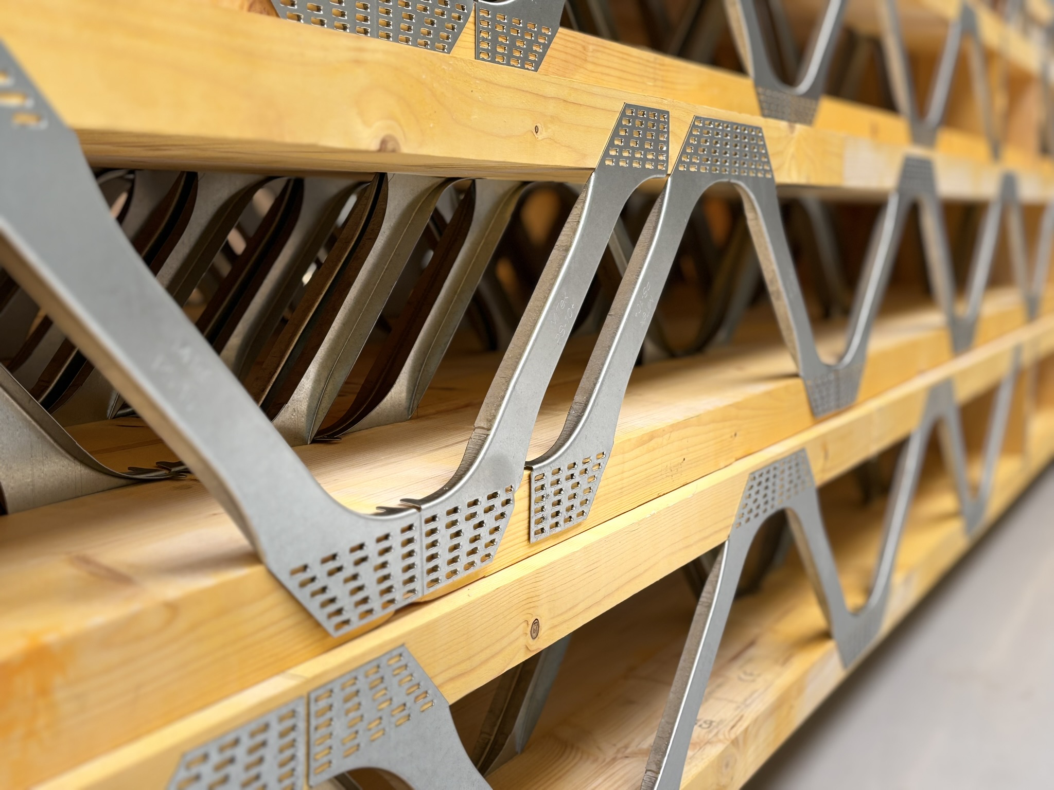 Close-up of Posi-Joist steel V-webs pressed into timber chords