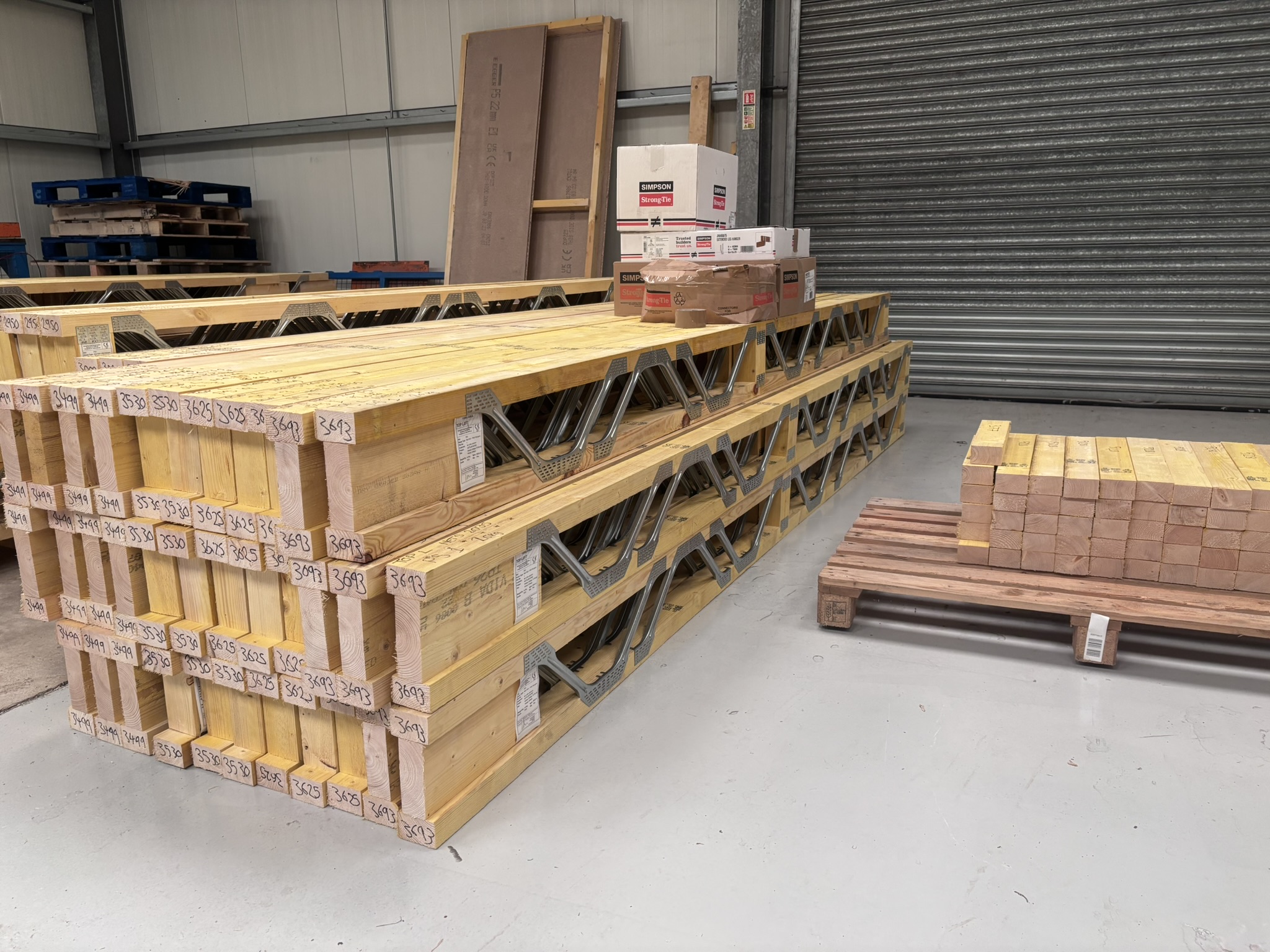 Packs of Posi-Joists on pallets in the HETS factory