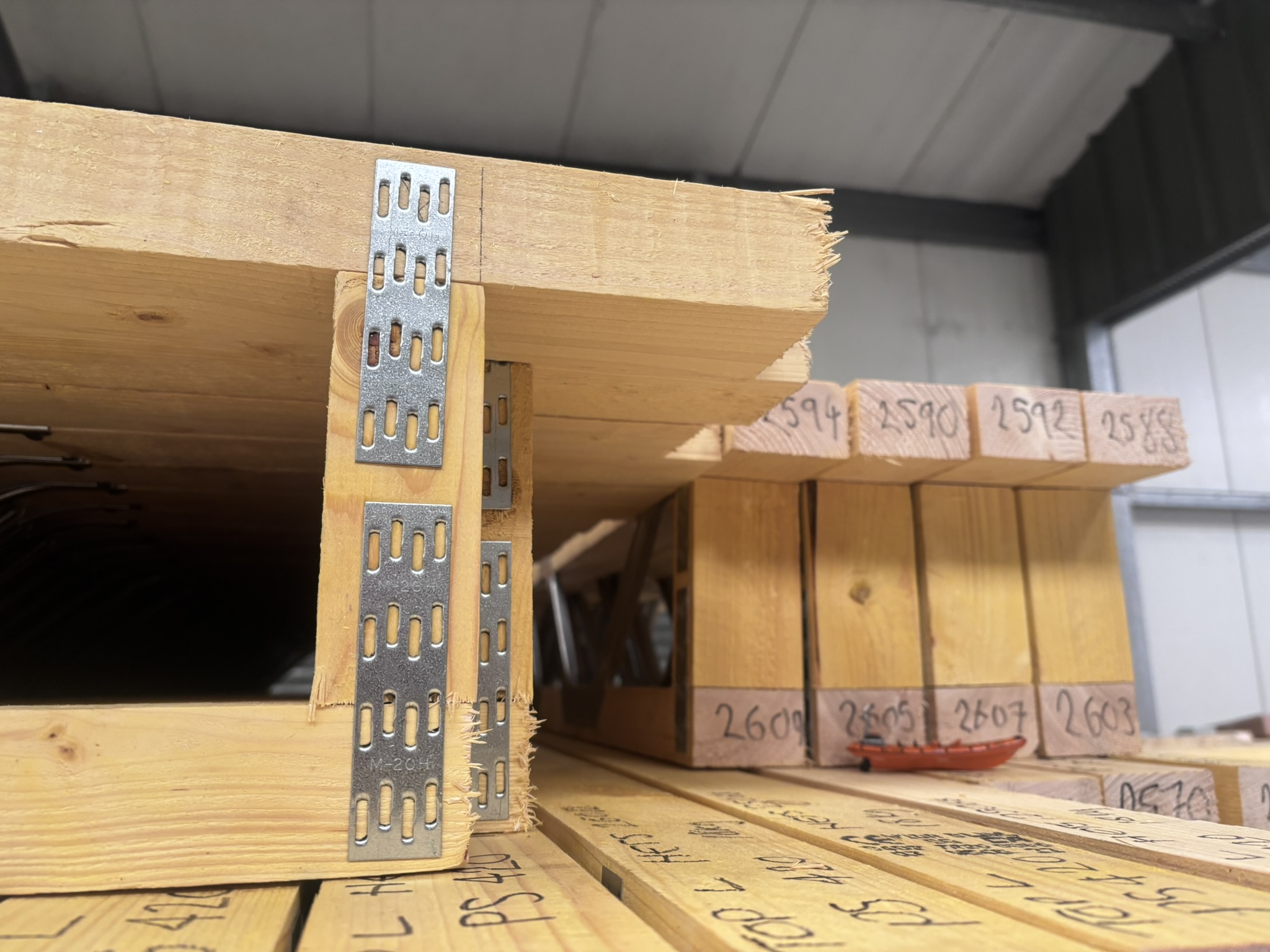 Posi-Joists with steel straps stacked in the HETS factory