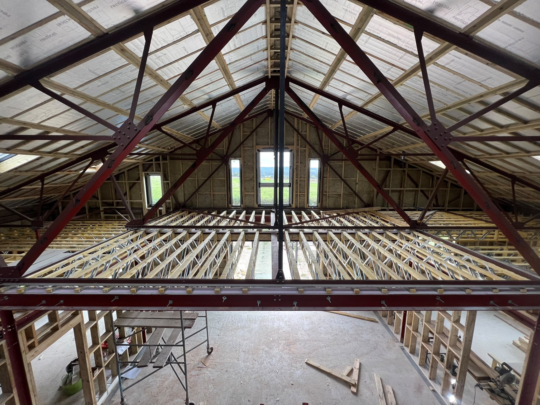Posi-Joist first floor installed inside a steel-framed hangar conversion self-build in Midhurst, West Sussex